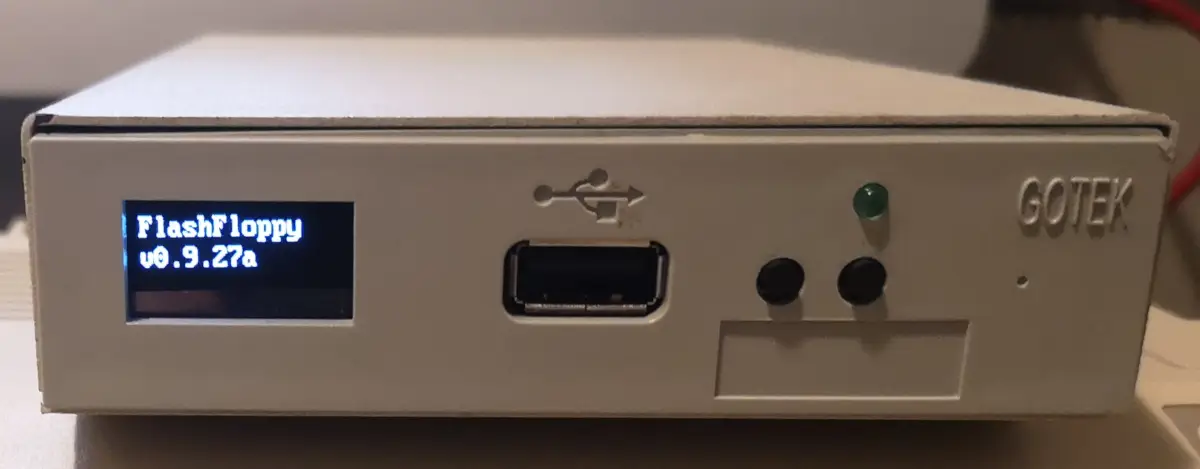Gotek Floppy Emulator with oled screen in external 3.5" floppy casing showing FlashFloppy firmware v 0.9.27a