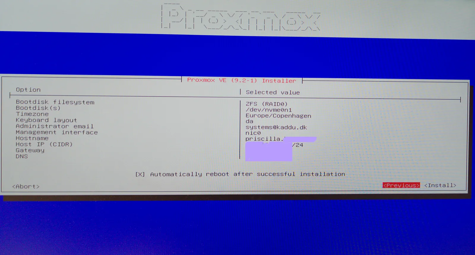 The installer’s summary: ZFS (RAID0) on /dev/nvme0n1, Europe/Copenhagen, keyboard da, hostname priscilla, and Automatically reboot after successful installation ticked