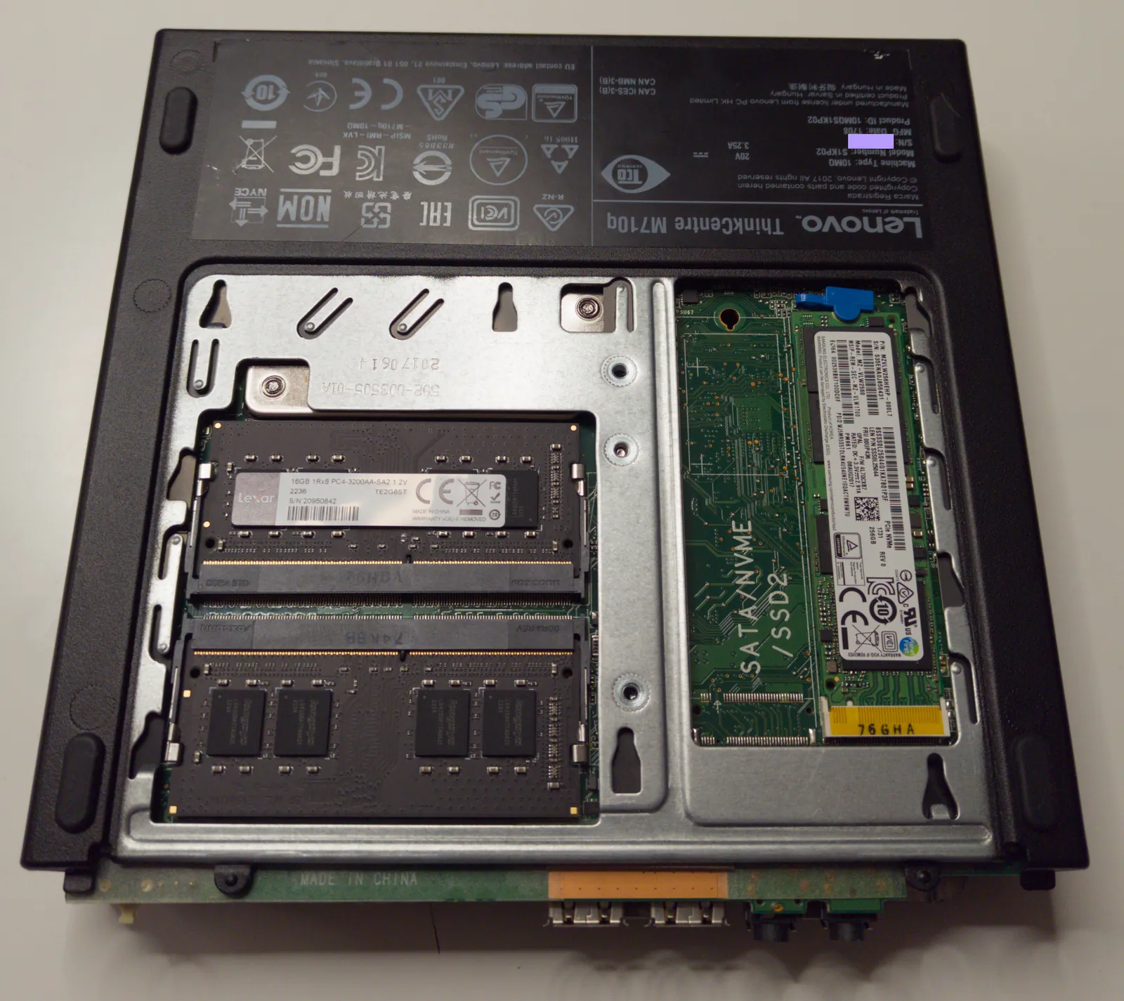 The underside of the M710q opened, with two memory modules and an NVMe drive in the M.2 slot